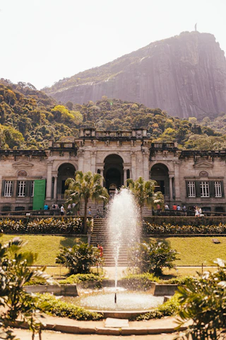 a large building with a fountain in front of it