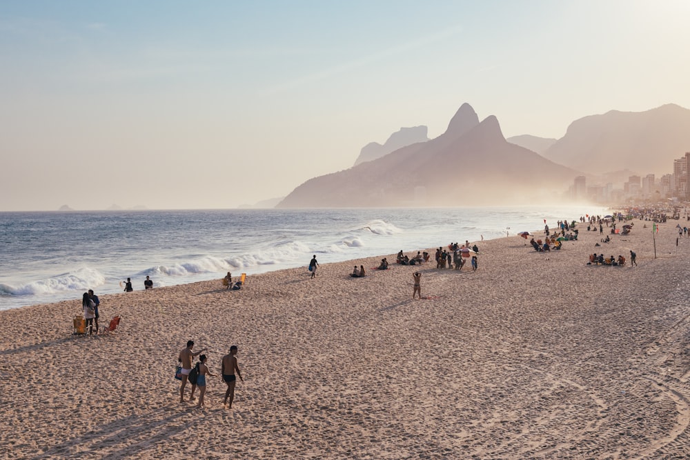 a large group of people on a beach with Ipanema in the background