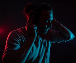 A user adjusting their ear plugs for optimal sound quality.