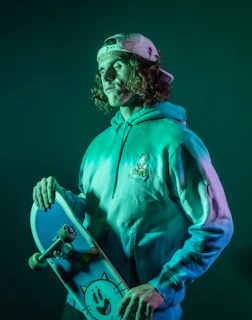 Dynamic shot of a youth skateboarding while sporting a neonpulse purple-accented streetwear hoodie