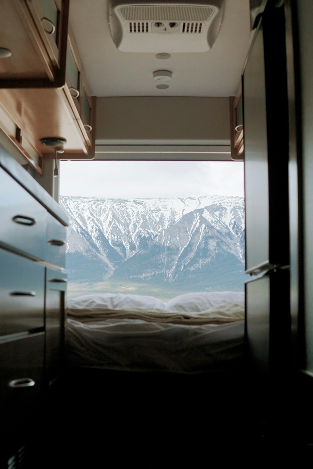 a view of a snowy mountain from a window