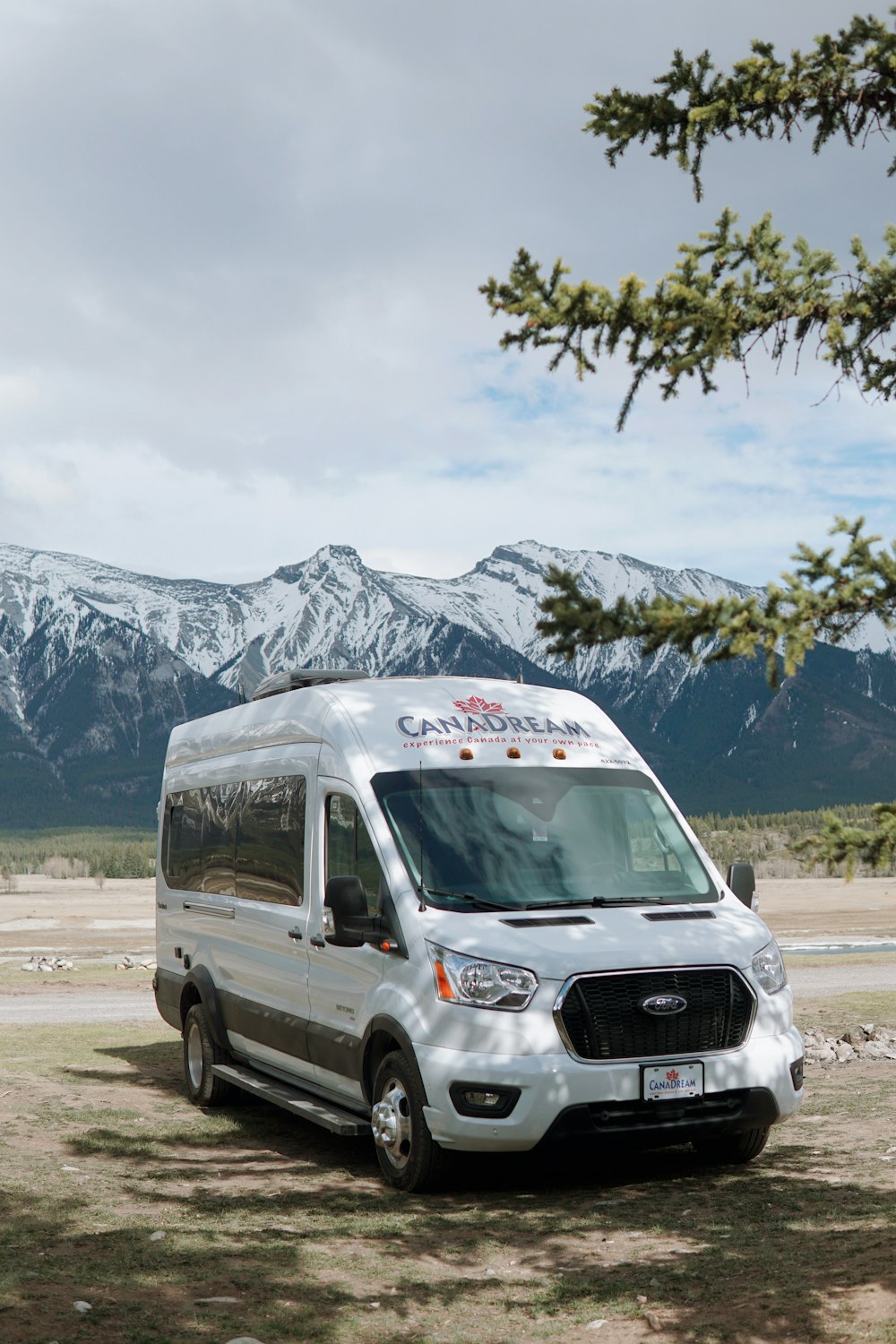 a white van parked in front of a mountain