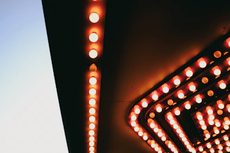 Historic marquee of Nostalgia Lumière glowing warmly on a crisp evening in Eureka.