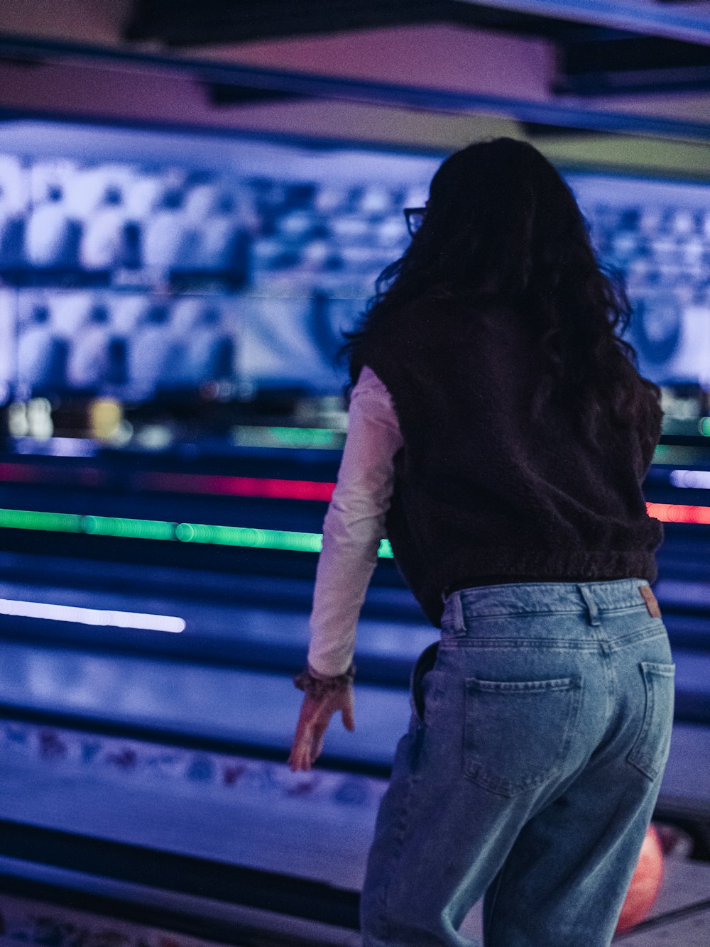 a person standing in front of a bowling alley