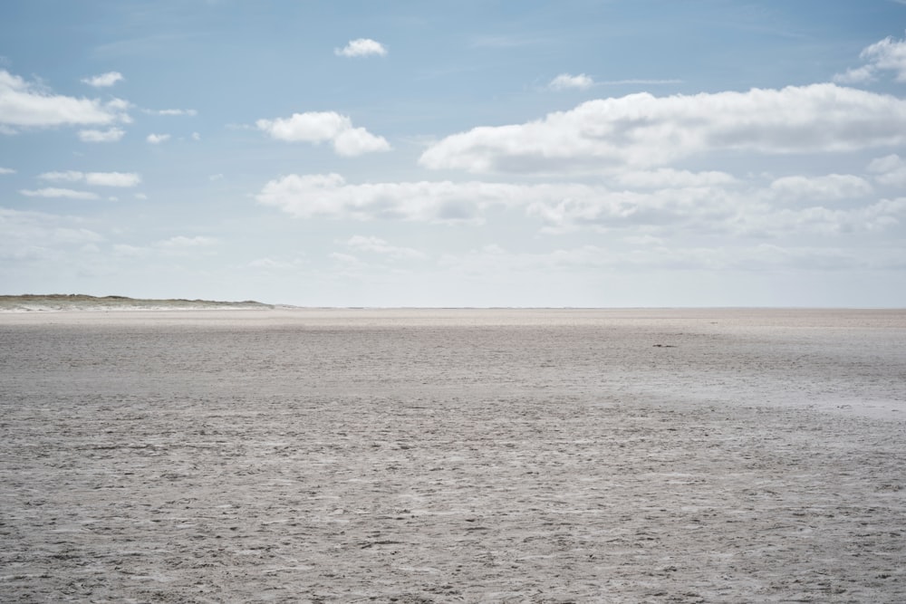 a large flat area with clouds in the sky