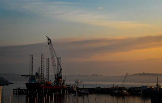 A calm offshore platform at sunset with crew members communicating by radio.