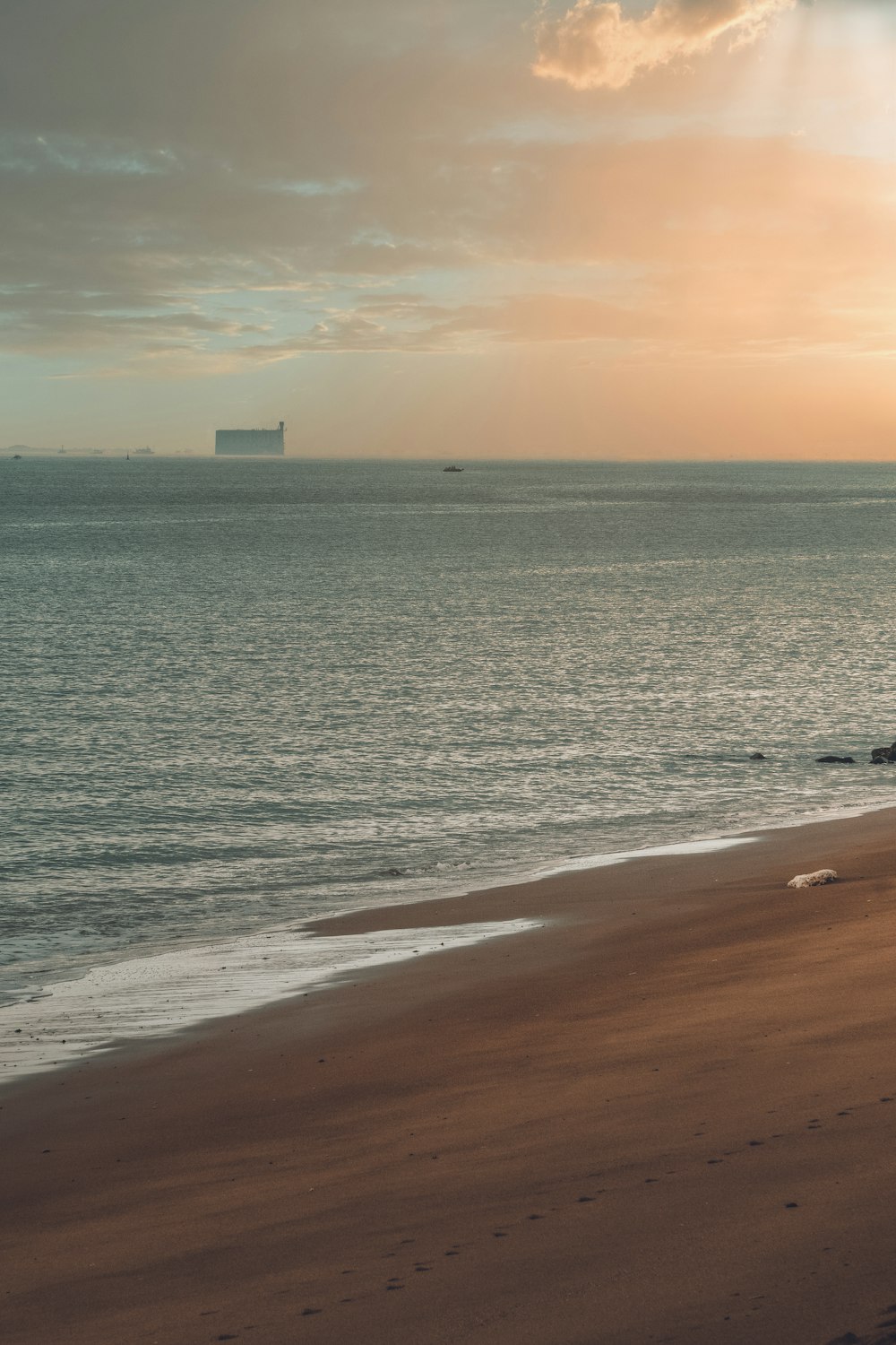 a beach with a building in the distance