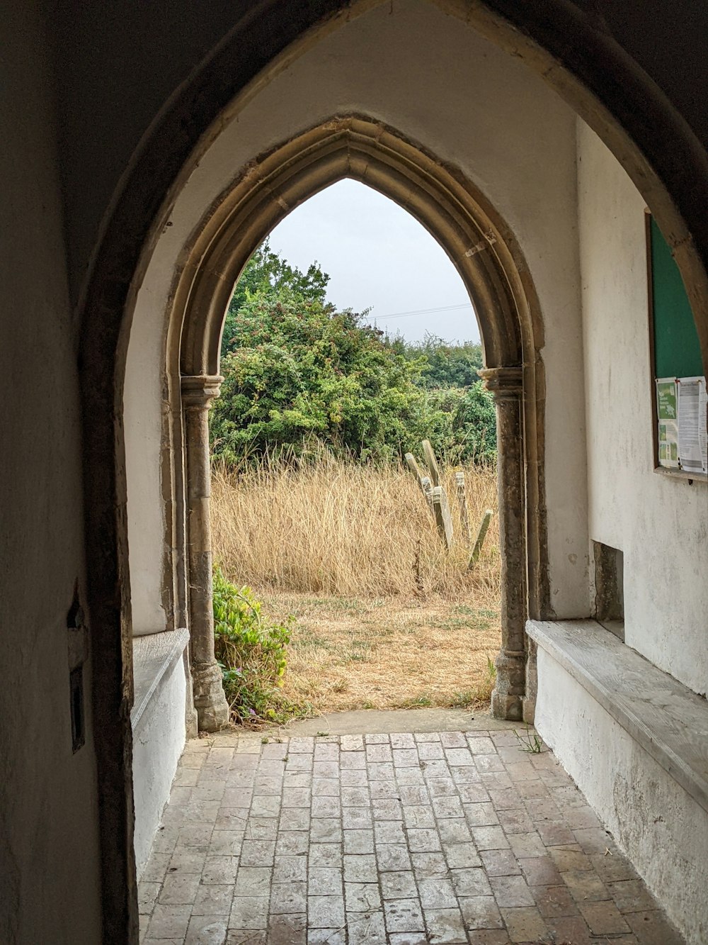 a stone walkway with a stone archway