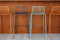 Colorful plastic barstool with a swivel seat and chrome legs, perfect for a vibrant kitchen.