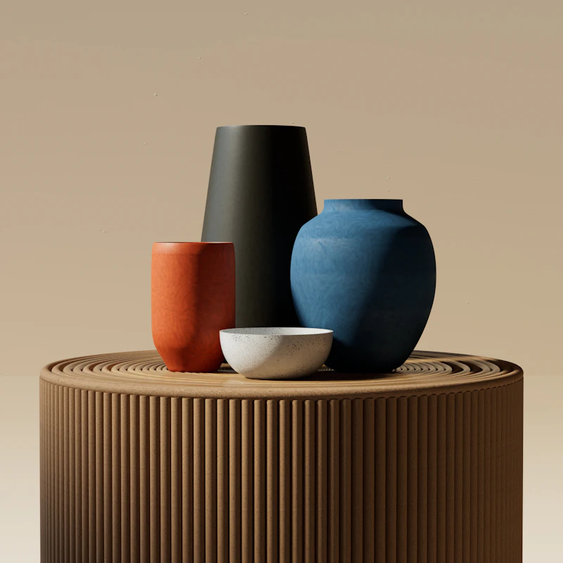 Stack of stoneware serving bowls beside a matching ceramic vase