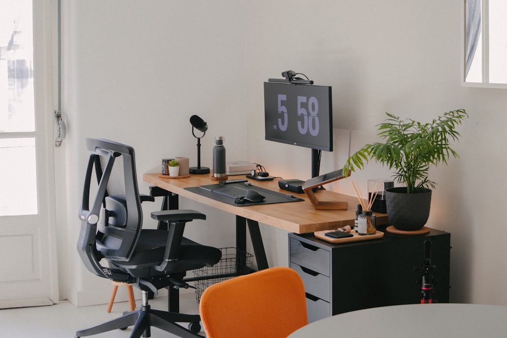 a desk with a computer and a chair in a room