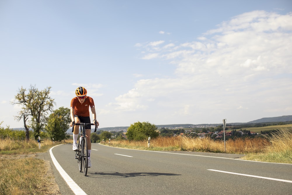 a man riding a bicycle on a road