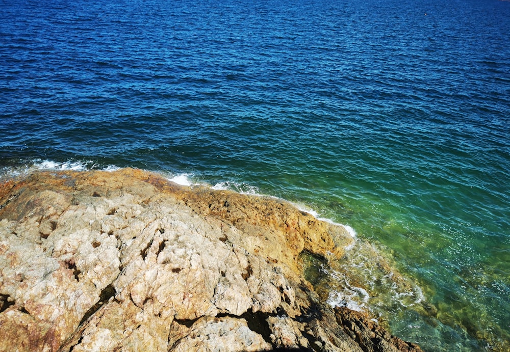 a rocky beach with blue water