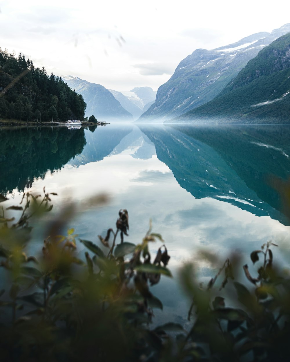 a body of water with mountains in the background