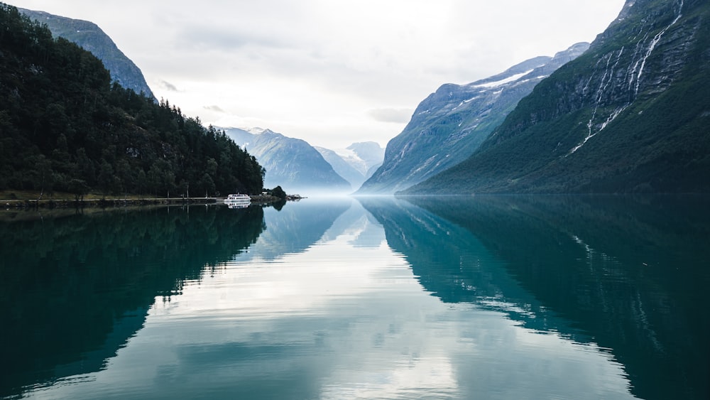 a body of water with mountains in the background