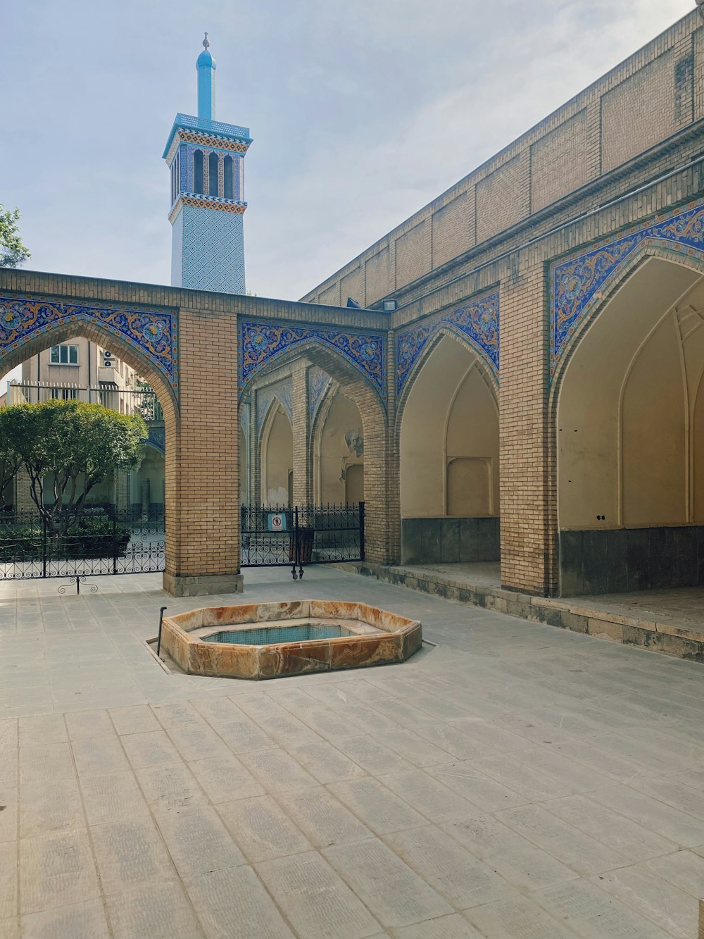 a large brick building with a fountain in front of it