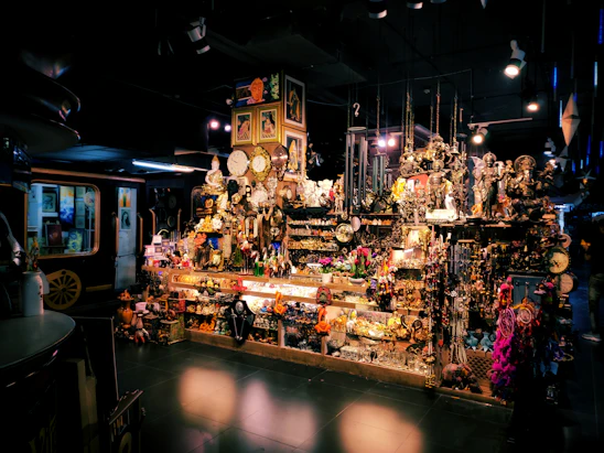 A vibrant montage showing a fishing rod beside a vintage antique clock, sports cards fanned out next to colorful toys in an inviting shop setting.