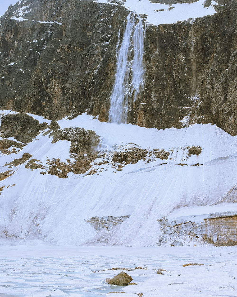 a waterfall in a snowy place