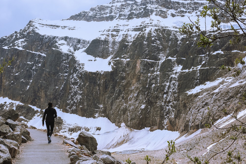 a person walking on a path in the snow