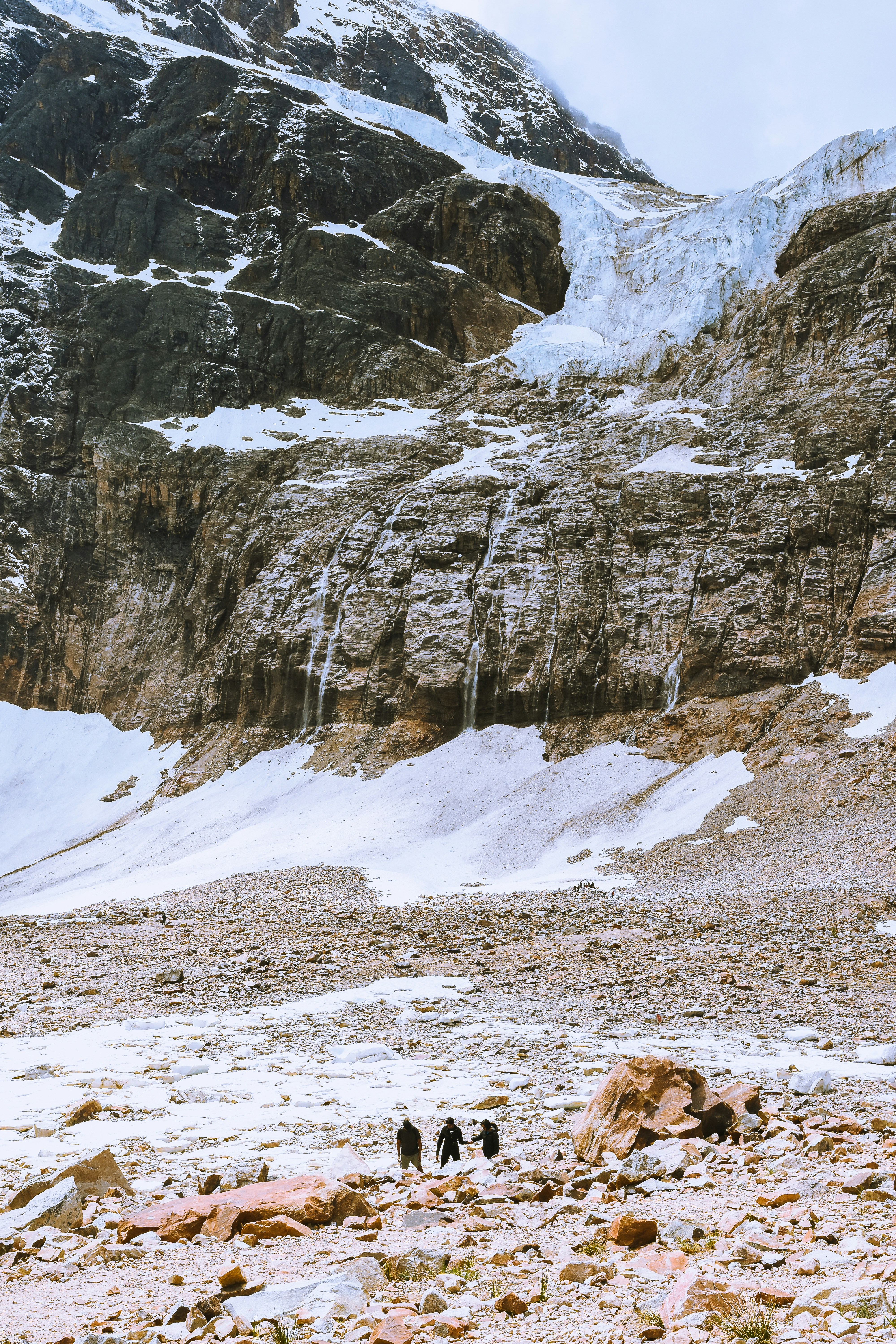 a group of people walking on a snowy mountain