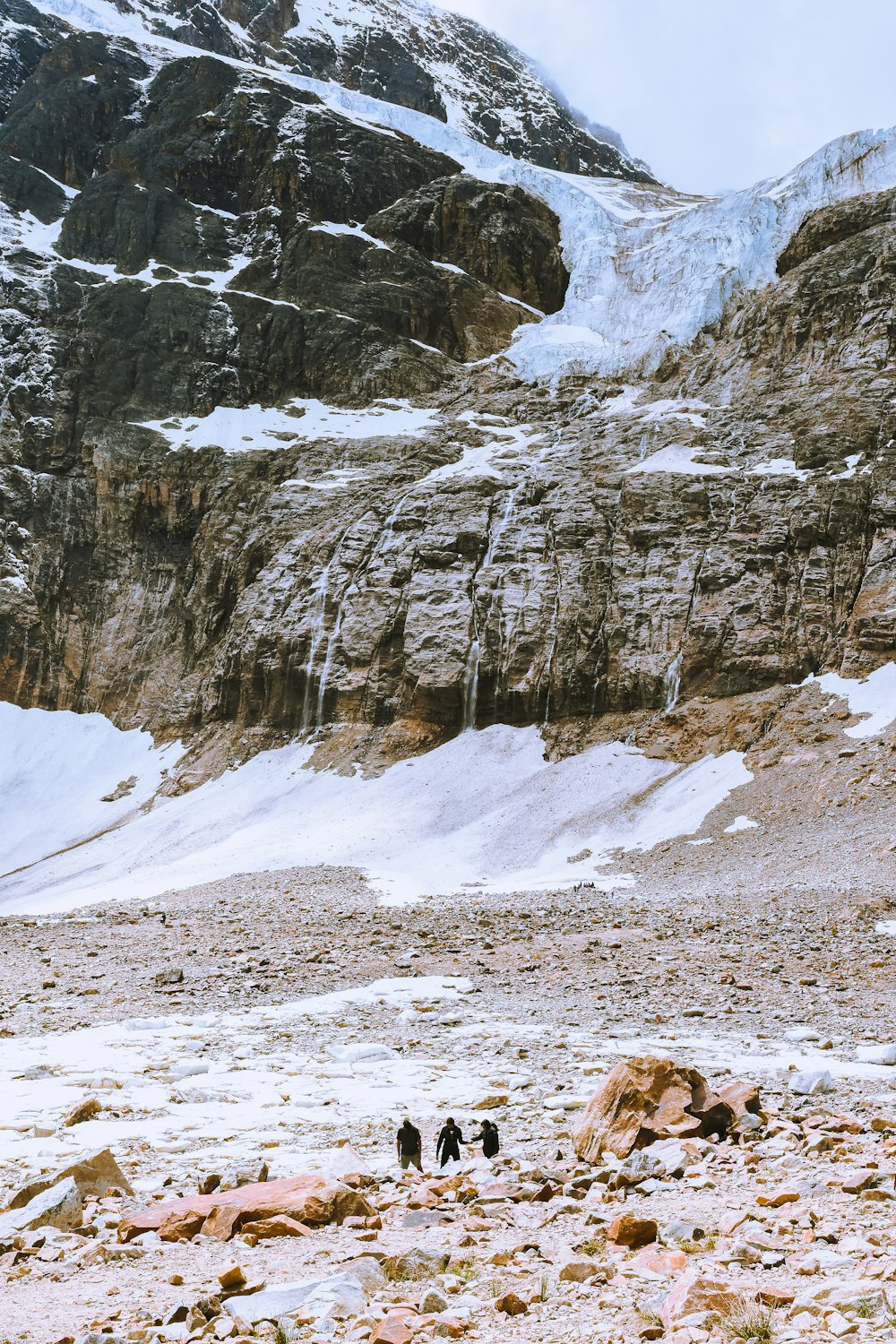 a group of people walking on a snowy mountain