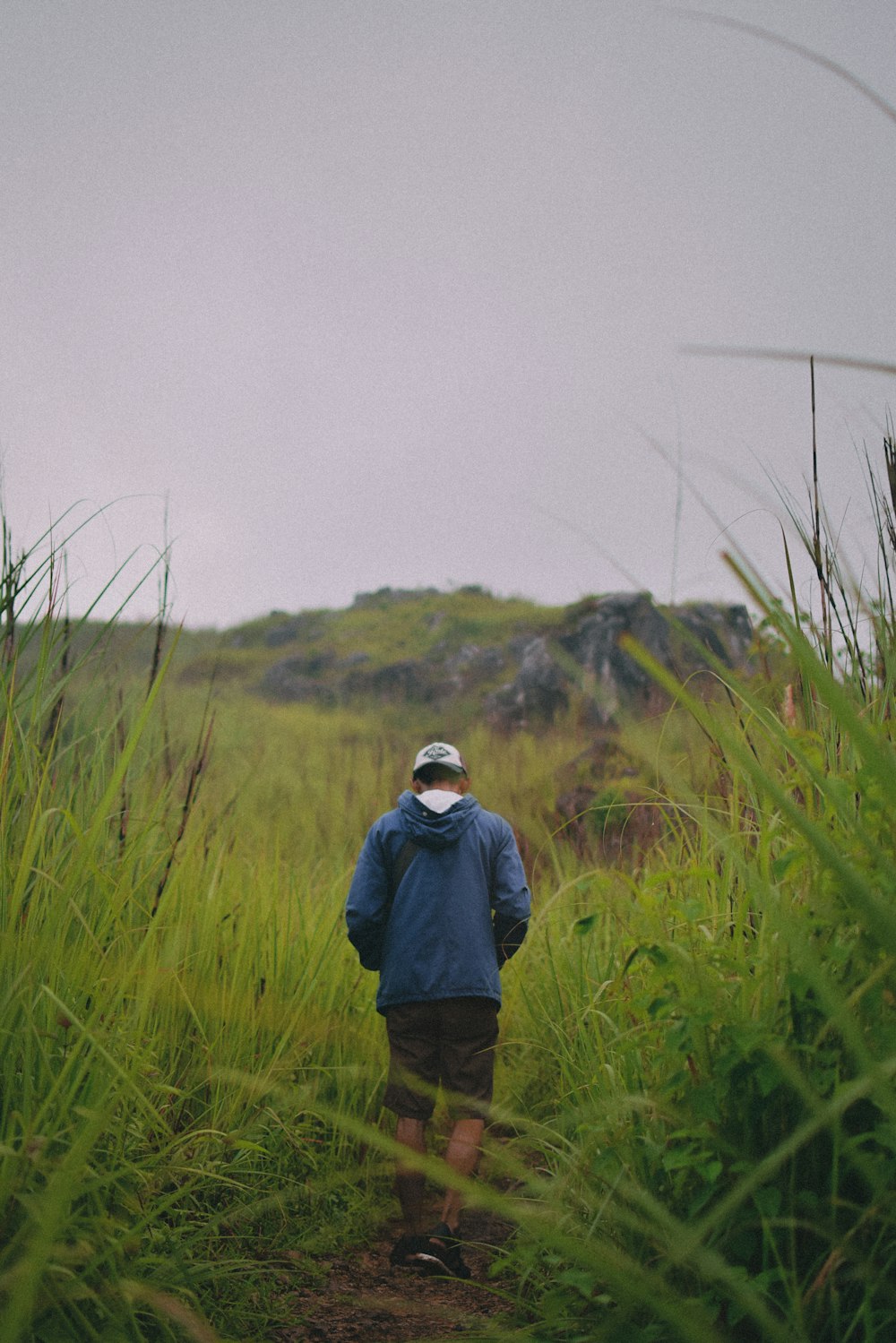 a man standing in a grassy area
