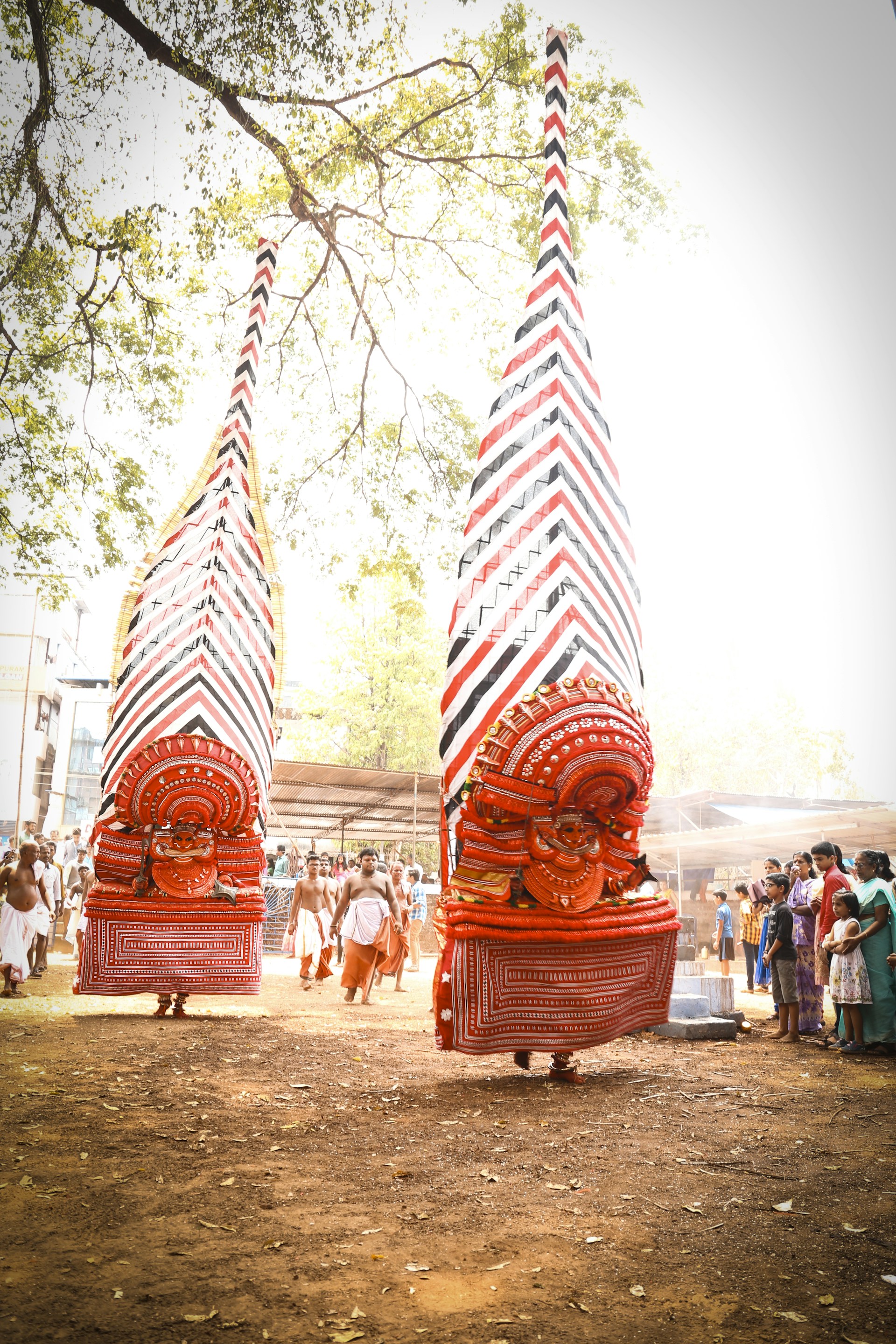 An outdoor cultural event with performers in traditional costume entertaining visitors amid the natural beauty of northern Bandung.