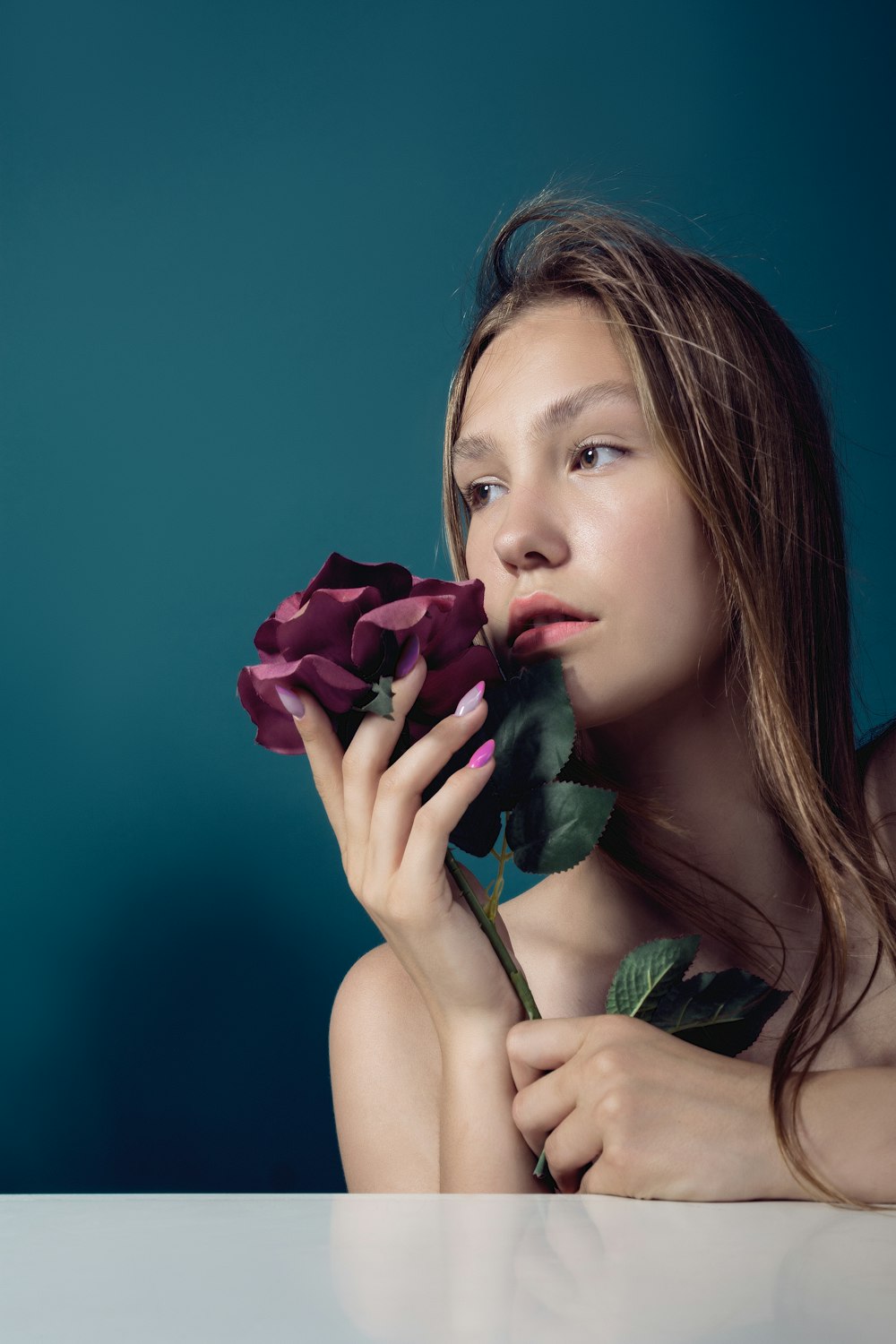 a woman holding a rose