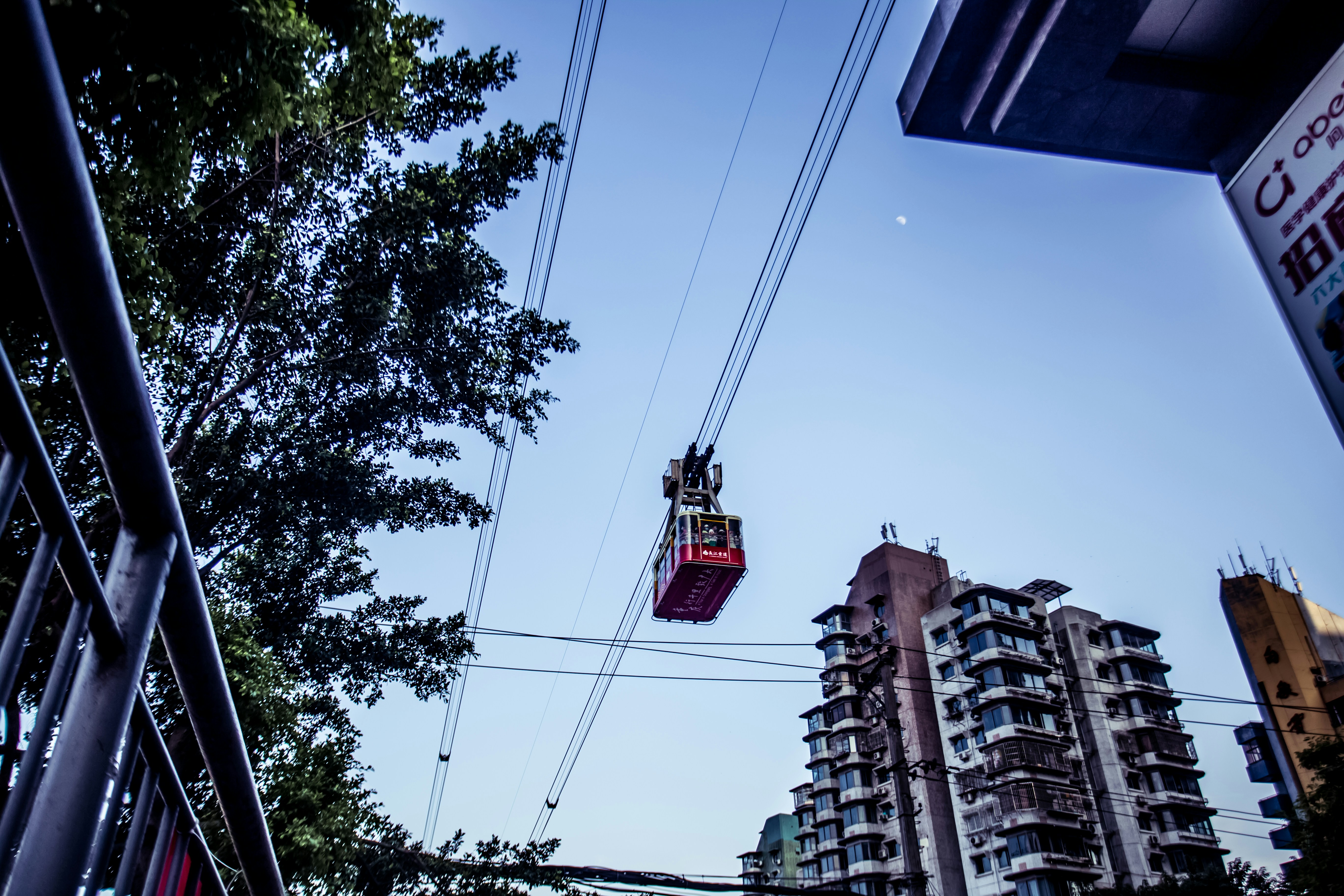a red chairlift in the air