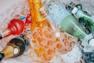 Bottles of sparkling water and soft drinks chilled in a vintage metal cooler.
