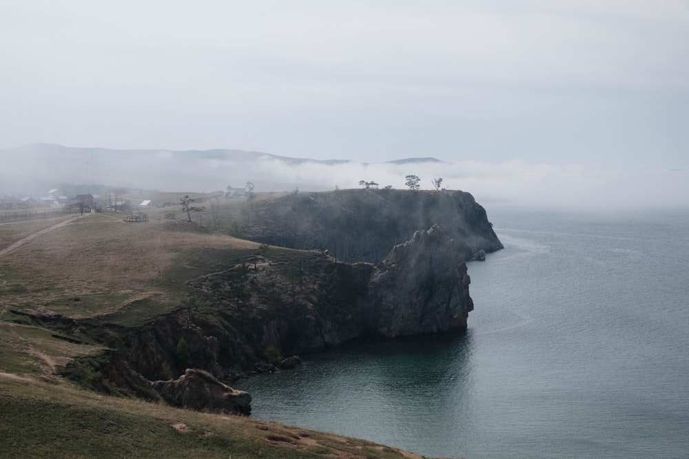 a cliff with a body of water below