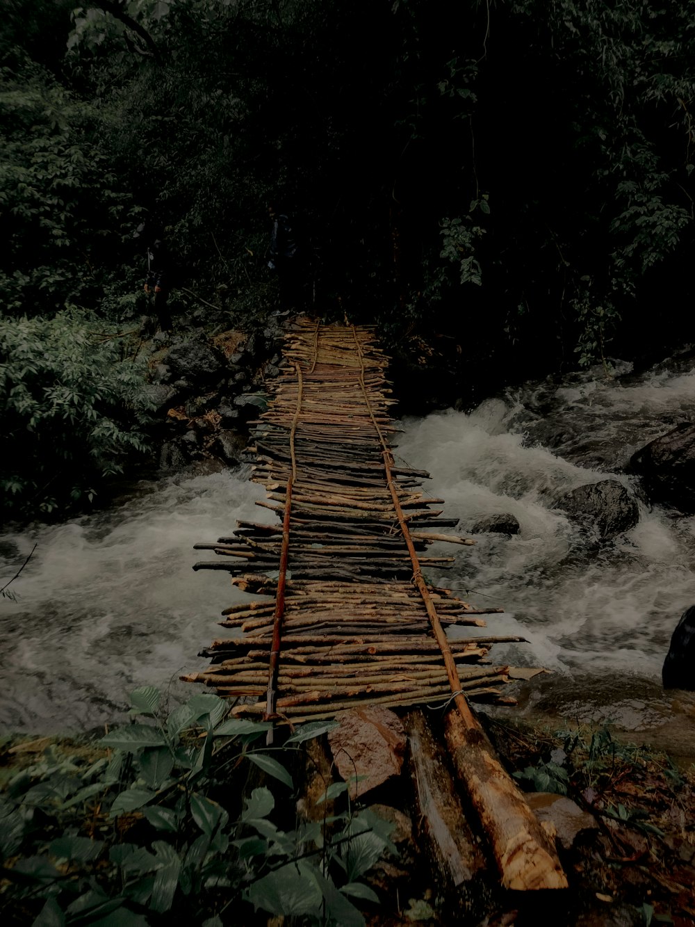 a wooden bridge over a river