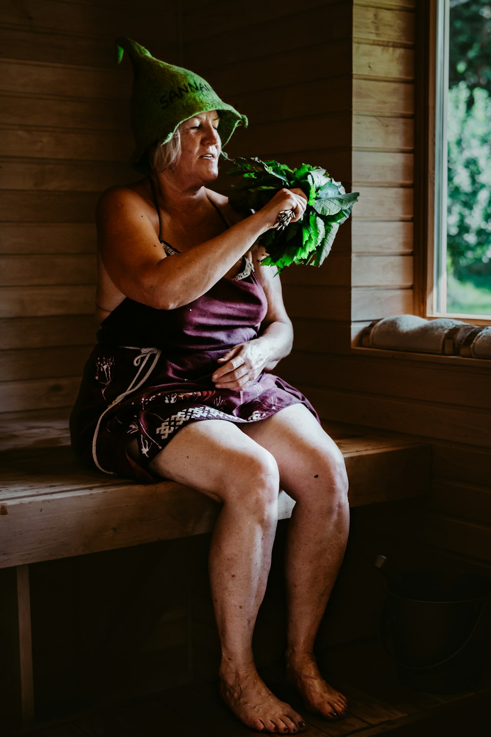 a person in a garment sitting on a bench