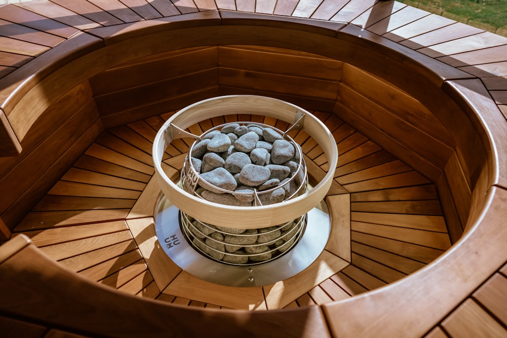 a bowl of rocks on a deck