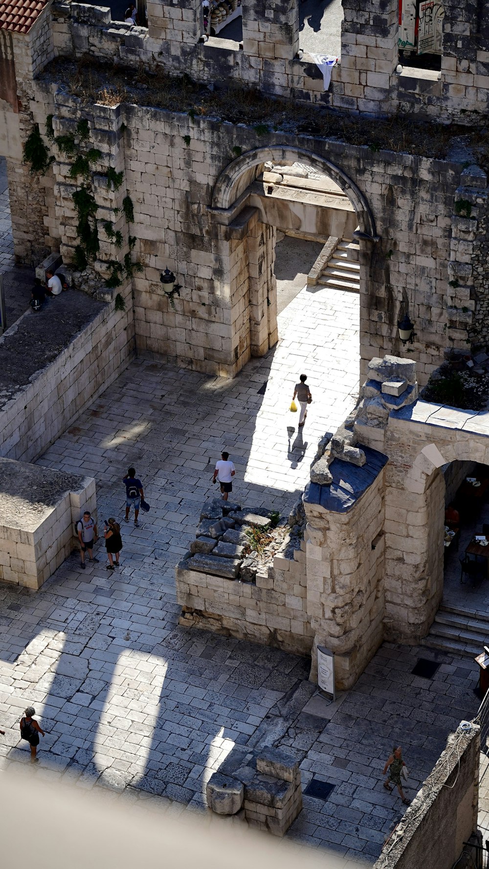 people walking on a stone walkway