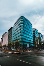 Professional business district with glass office buildings and busy urban environment.