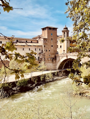 a river with a bridge and buildings