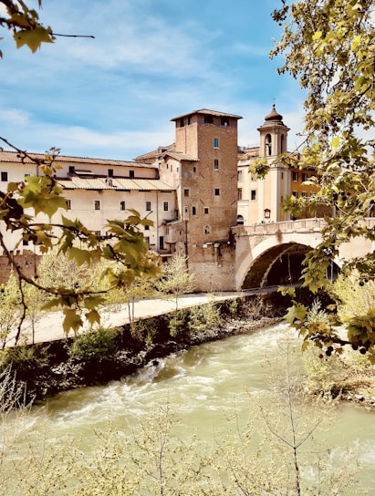 a river with a bridge and buildings