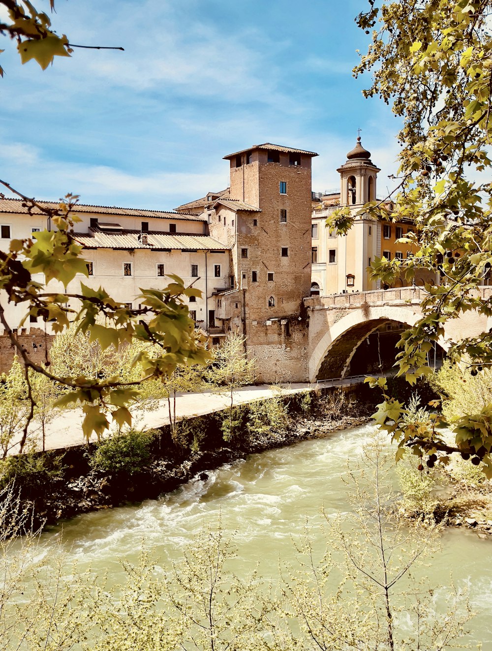 a river with a bridge and buildings