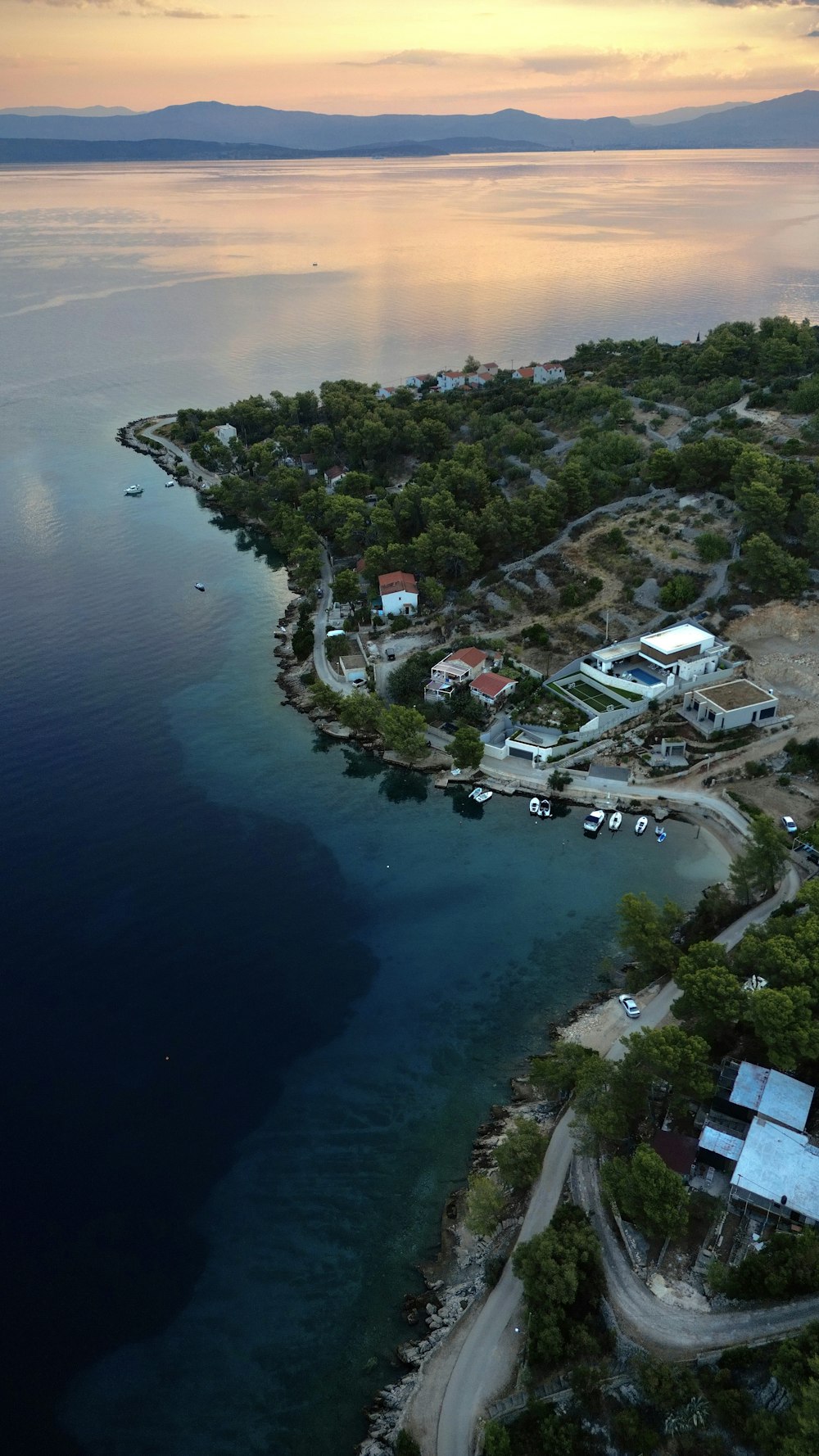 a body of water with buildings and trees around it