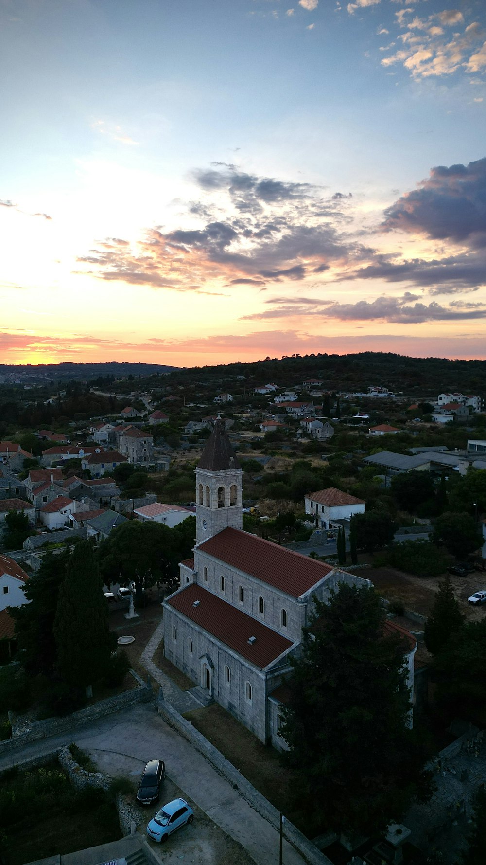 a city with a church and a sunset