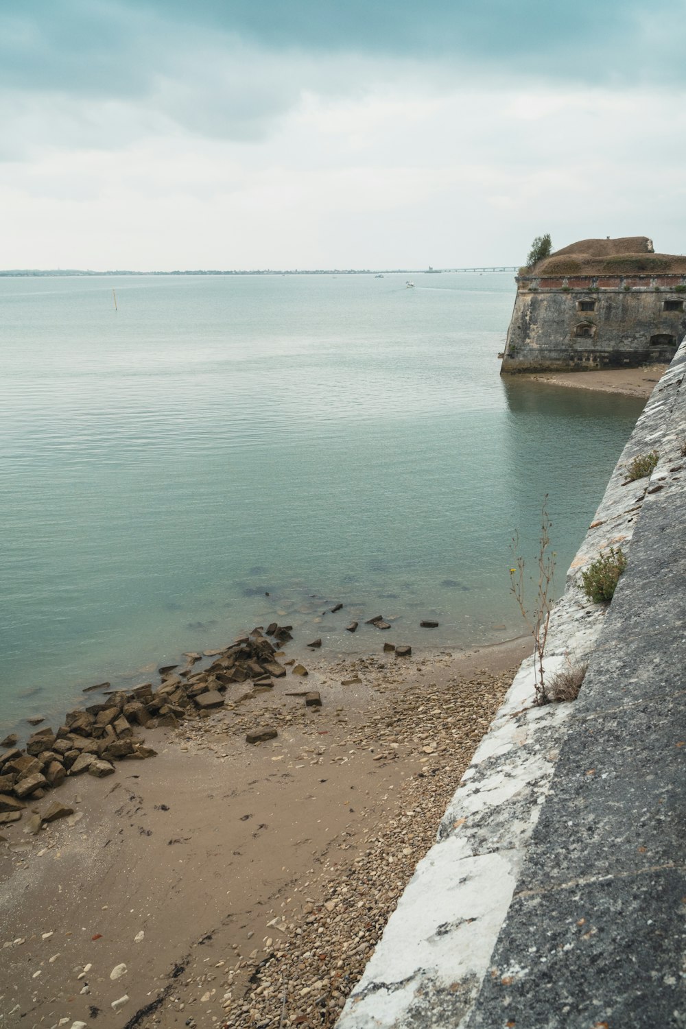 a rocky beach next to a body of water