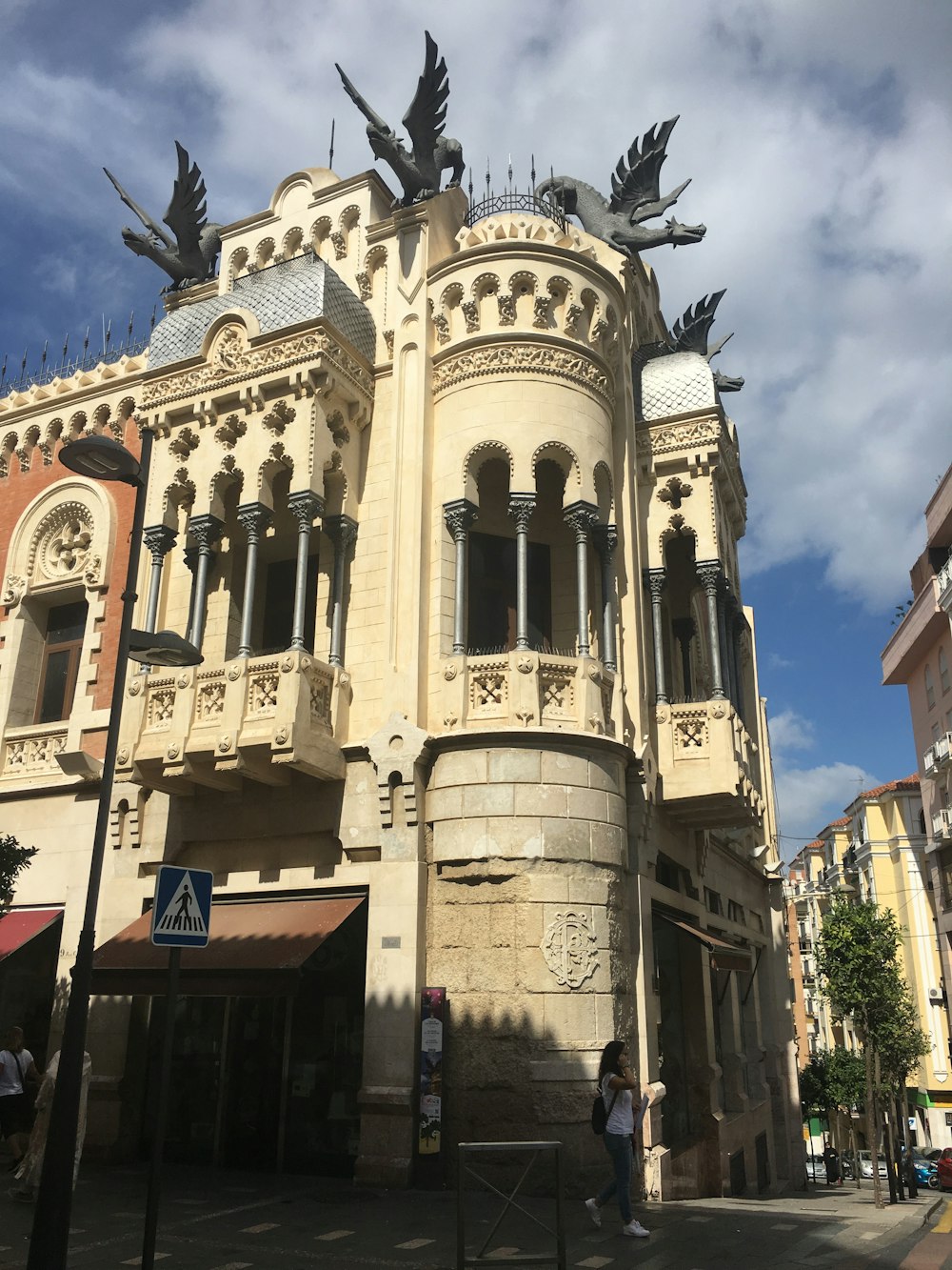 a large stone building with statues on top