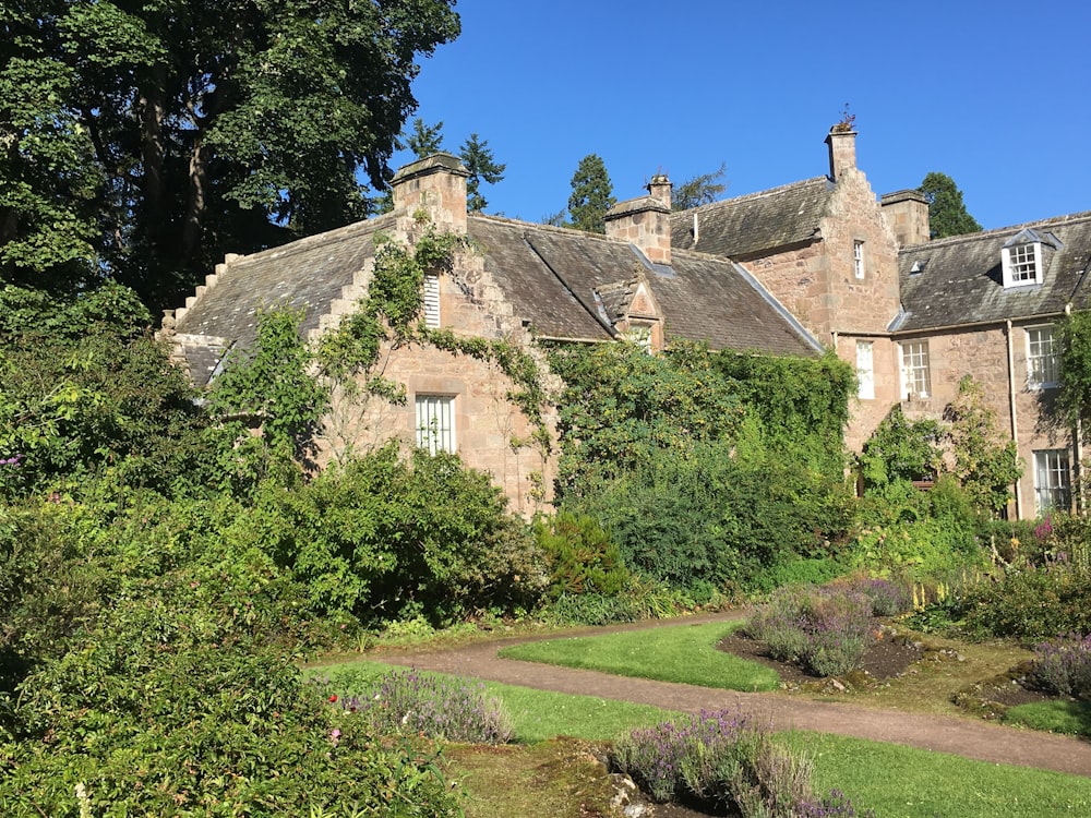 a stone building with a garden in front of it