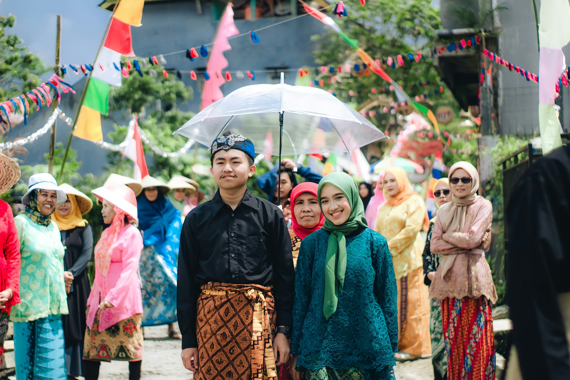 a group of people standing under an umbrella