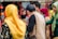 Guests engaging in lively, joyful conversation during a cultural gala event.