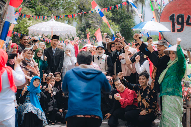 A group photo capturing joyful moments at an outdoor celebration.