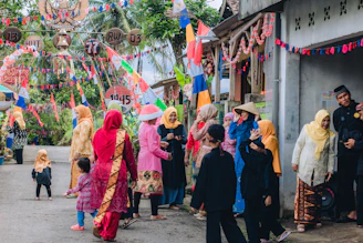 A lively street scene on Boundary Road with people in colorful traditional attire celebrating National Dress Day.