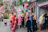 Group of happy tourists exploring a colorful street festival in Bata.