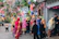 Group of happy tourists exploring a colorful street festival in Bata.